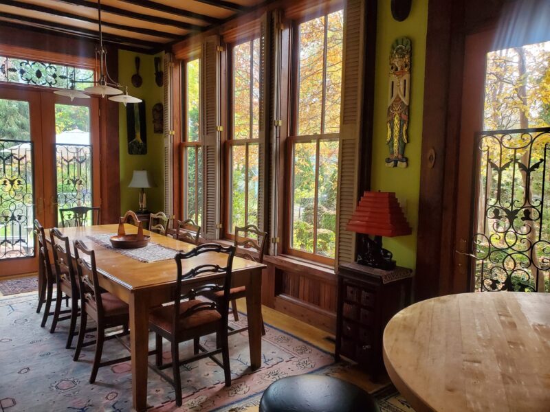 Carriage House Dining Room Table showing doors to back patio and side to porch